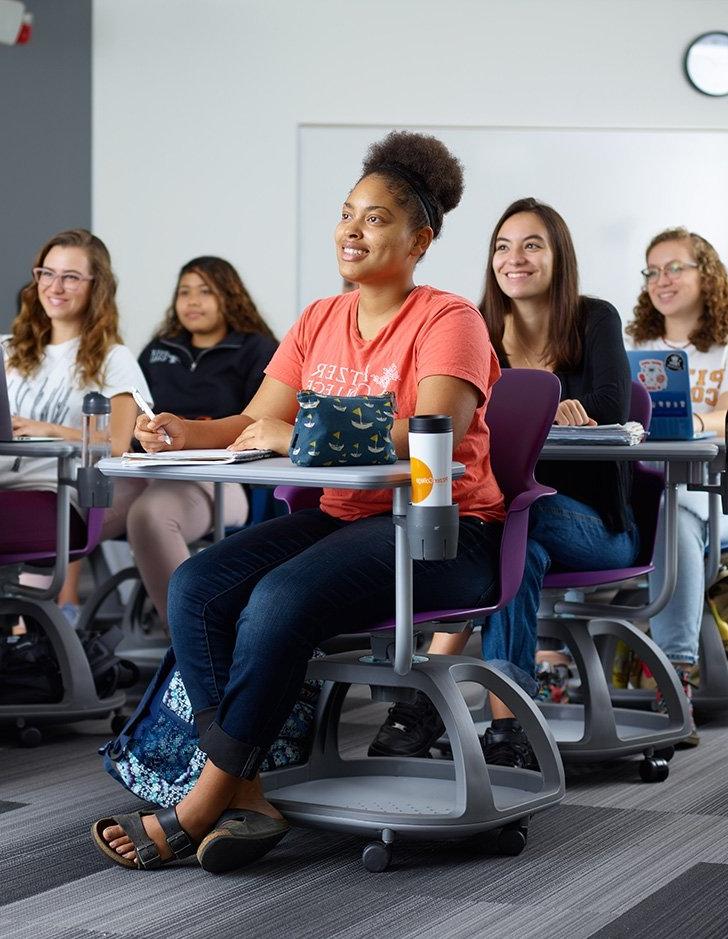 students sit in adjustable desks in a Pitzer classroom